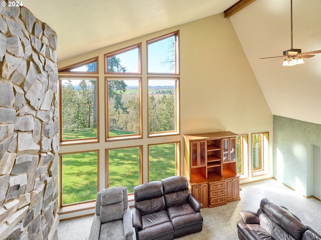 living room with ceiling fan, light colored carpet, high vaulted ceiling, and plenty of natural light