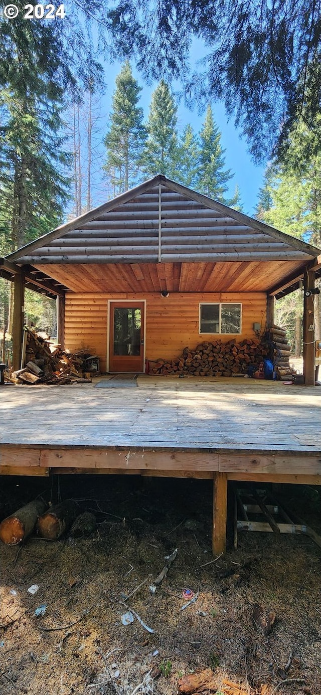 back of property with a wooden deck