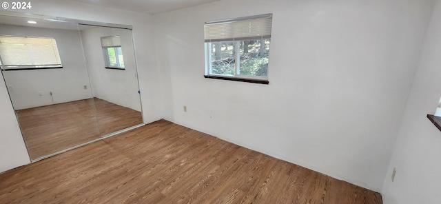 spare room featuring plenty of natural light and hardwood / wood-style floors