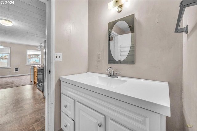 bathroom featuring ceiling fan and vanity