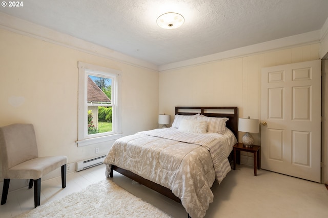 bedroom featuring a textured ceiling and a baseboard radiator