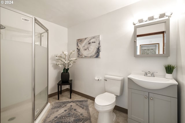 bathroom with tile patterned flooring, vanity, toilet, and walk in shower