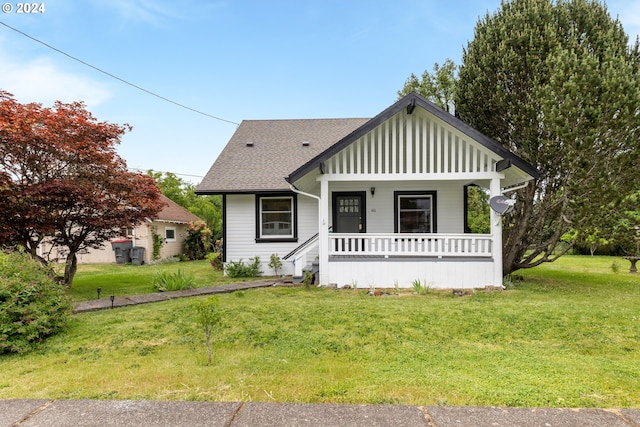 view of front facade featuring a front lawn and covered porch