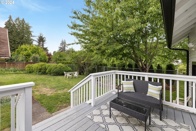 wooden terrace with a lawn