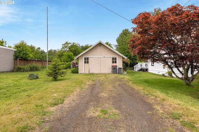 view of home's exterior featuring a yard and a storage unit