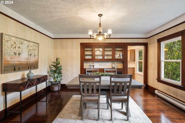 dining space featuring dark hardwood / wood-style floors, an inviting chandelier, a textured ceiling, and a baseboard heating unit