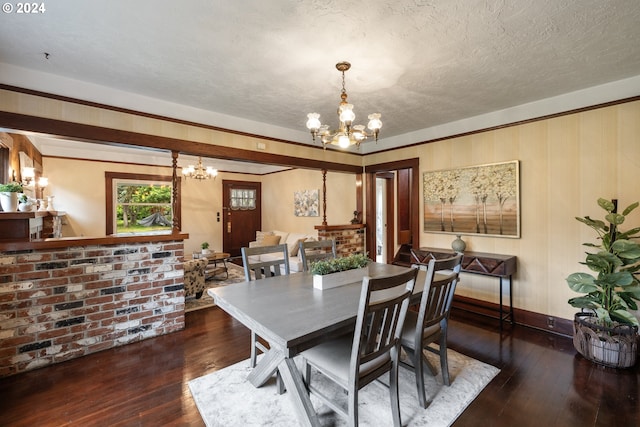 dining room with a textured ceiling, dark hardwood / wood-style floors, and a notable chandelier