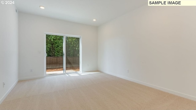 unfurnished room featuring light carpet