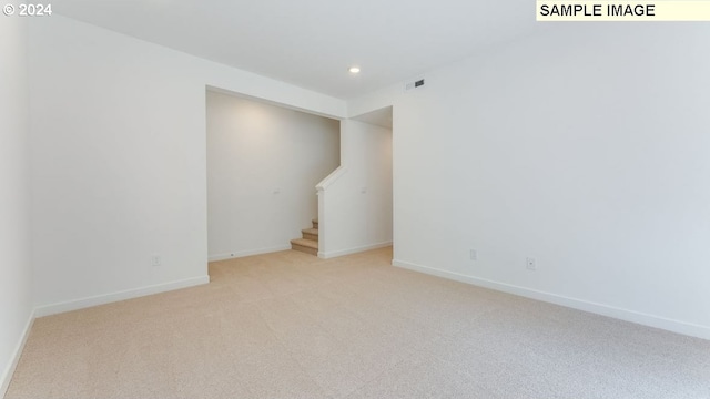 empty room featuring light colored carpet