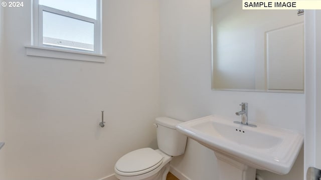 bathroom featuring sink and toilet