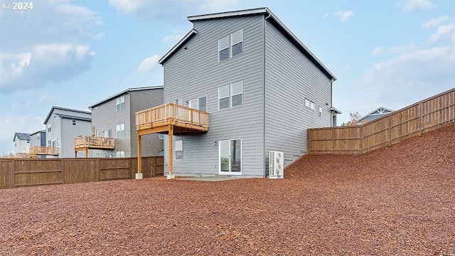 back of property with a balcony and a patio area