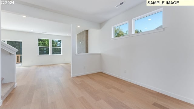 empty room featuring light hardwood / wood-style floors and a healthy amount of sunlight