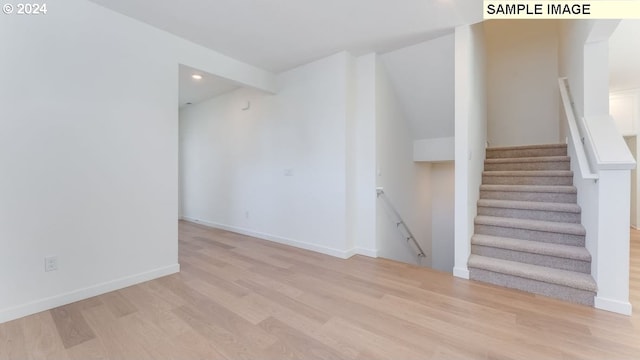 staircase with wood-type flooring