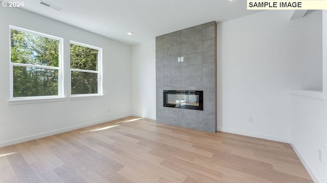 unfurnished living room with light hardwood / wood-style floors and a fireplace