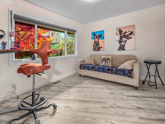 sitting room featuring hardwood / wood-style flooring and a textured ceiling