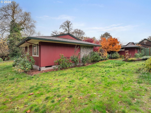 view of property exterior featuring a lawn