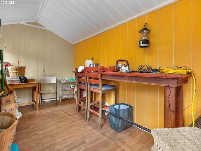 bedroom featuring wood-type flooring and vaulted ceiling