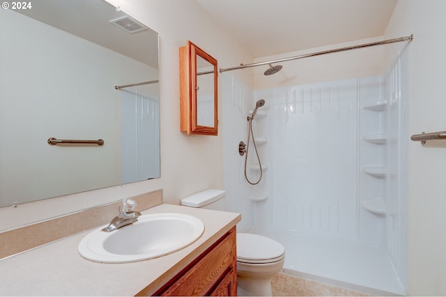 bathroom featuring tile patterned floors, a shower, vanity, and toilet