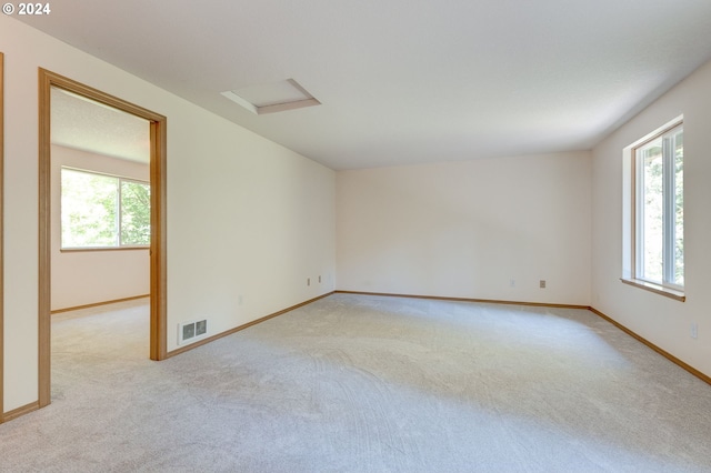 carpeted empty room featuring plenty of natural light