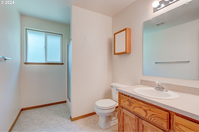 bathroom featuring walk in shower, vanity, and toilet