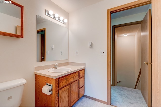 bathroom with vanity, toilet, and a textured ceiling