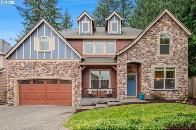 view of front of house featuring driveway, a garage, a shingled roof, covered porch, and a front lawn