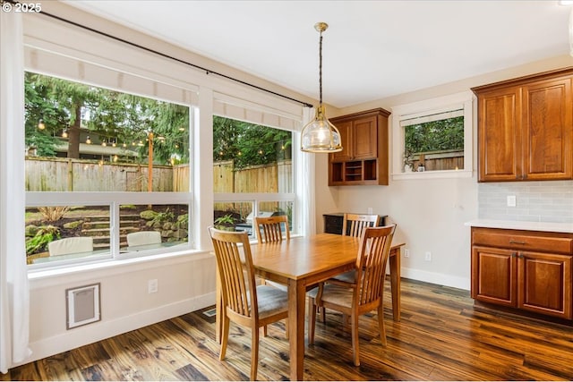 dining area with dark wood-style floors and baseboards