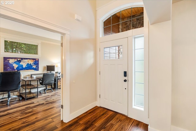 foyer featuring dark wood-style floors and baseboards