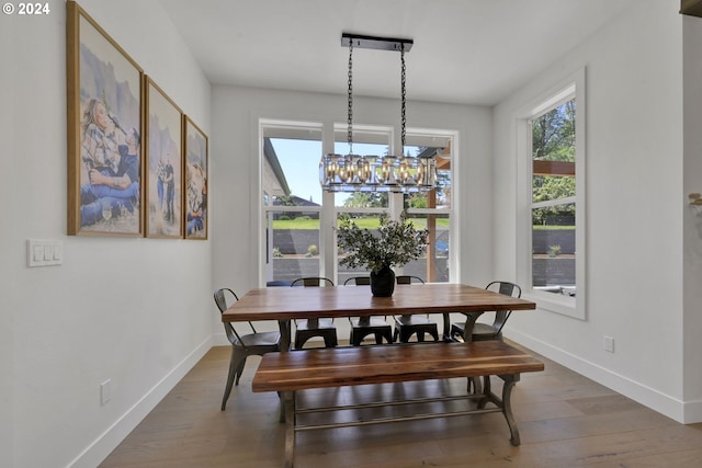 dining area featuring a chandelier and wood-type flooring