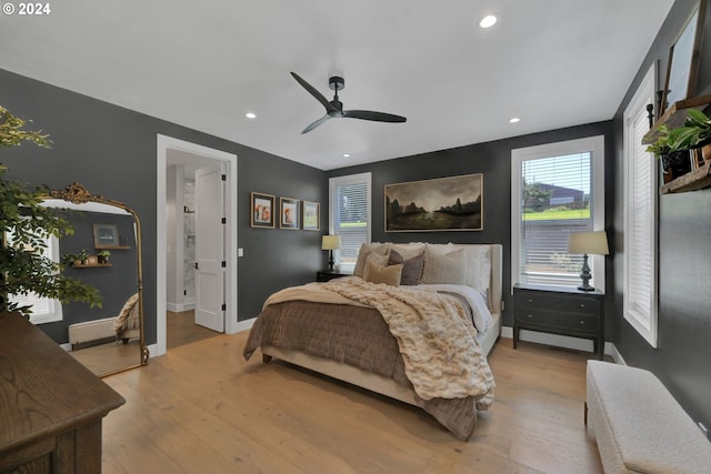 bedroom with connected bathroom, light hardwood / wood-style flooring, and ceiling fan