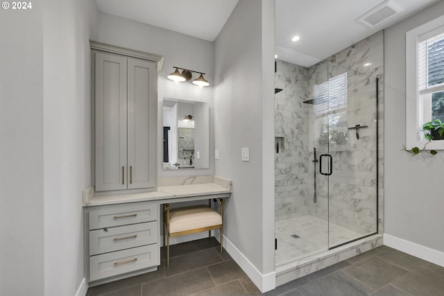 bathroom featuring tile patterned floors, vanity, and walk in shower