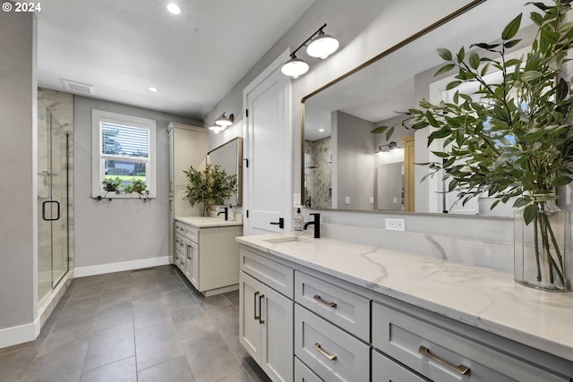 bathroom featuring vanity and a shower with shower door