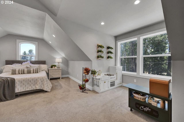 carpeted bedroom with vaulted ceiling and multiple windows