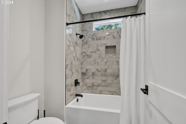 bathroom featuring shower / bath combo and toilet