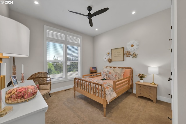 bedroom featuring light colored carpet and ceiling fan