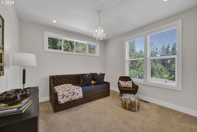 sitting room with carpet flooring and an inviting chandelier