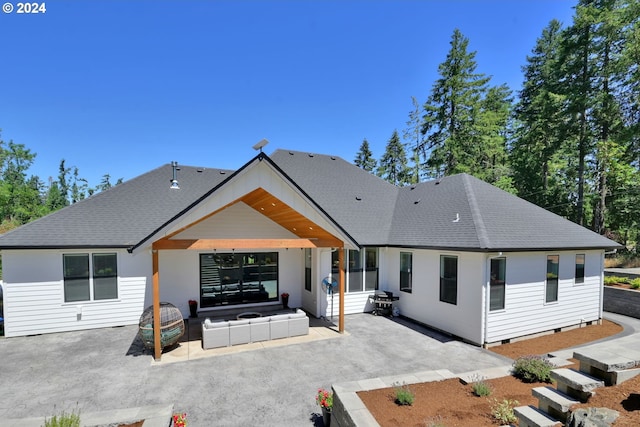 rear view of house with outdoor lounge area and a patio