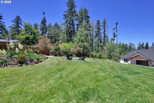 view of yard with an outdoor fire pit