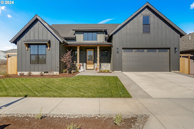 modern inspired farmhouse with a front yard and a garage