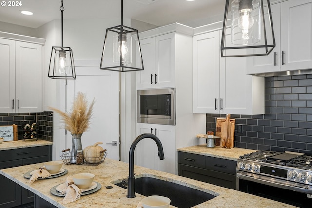 kitchen with white cabinetry, stainless steel appliances, and sink