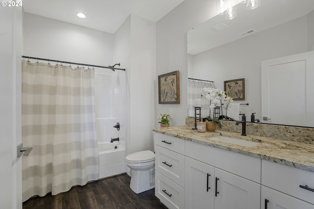 full bathroom with vanity, wood-type flooring, toilet, and shower / bath combo with shower curtain