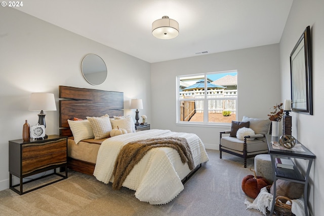 bedroom with light colored carpet