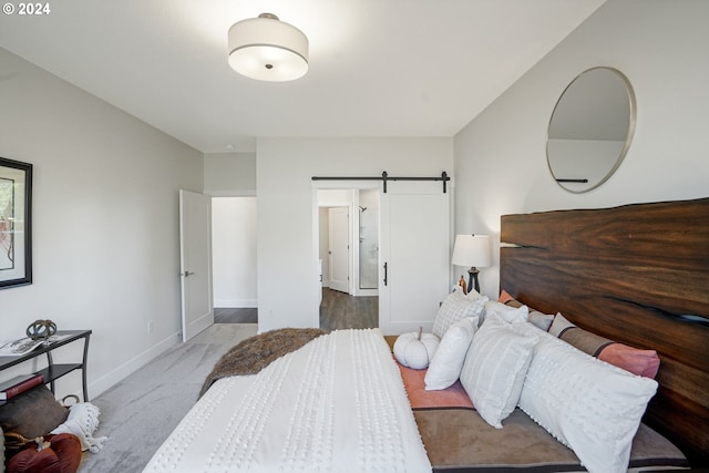 carpeted bedroom with a barn door