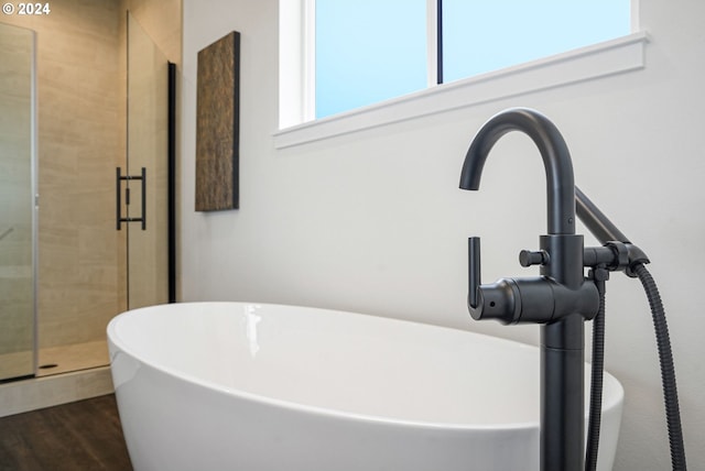 bathroom featuring hardwood / wood-style flooring, sink, and an enclosed shower