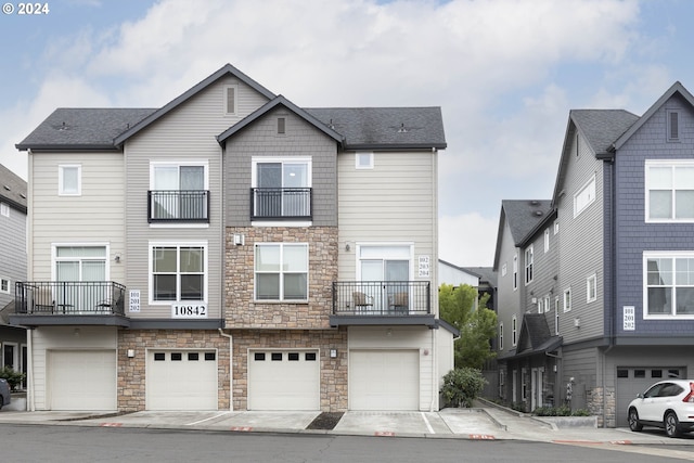 view of property featuring a balcony and a garage