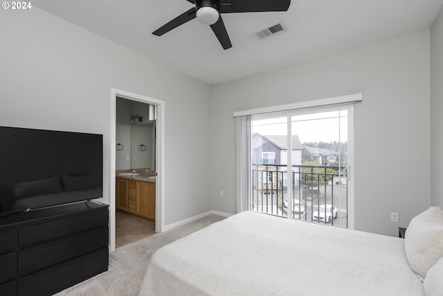 bedroom with visible vents, baseboards, ensuite bath, access to exterior, and light colored carpet