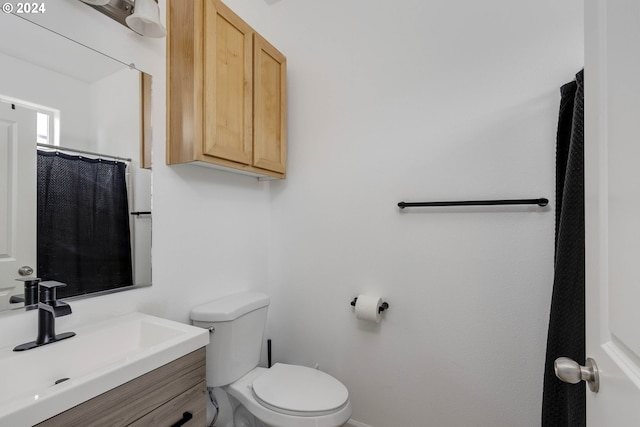 full bath featuring toilet and vanity