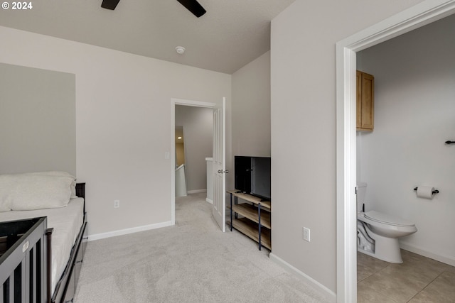 bedroom with baseboards and light carpet