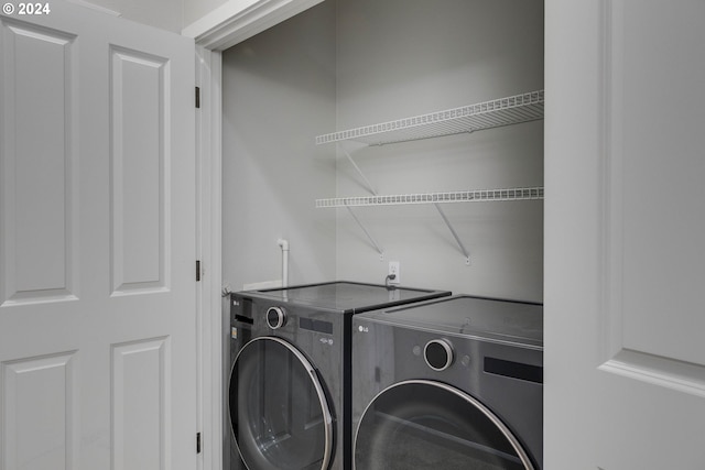 clothes washing area with laundry area and independent washer and dryer