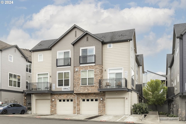 view of front facade featuring a garage and a balcony